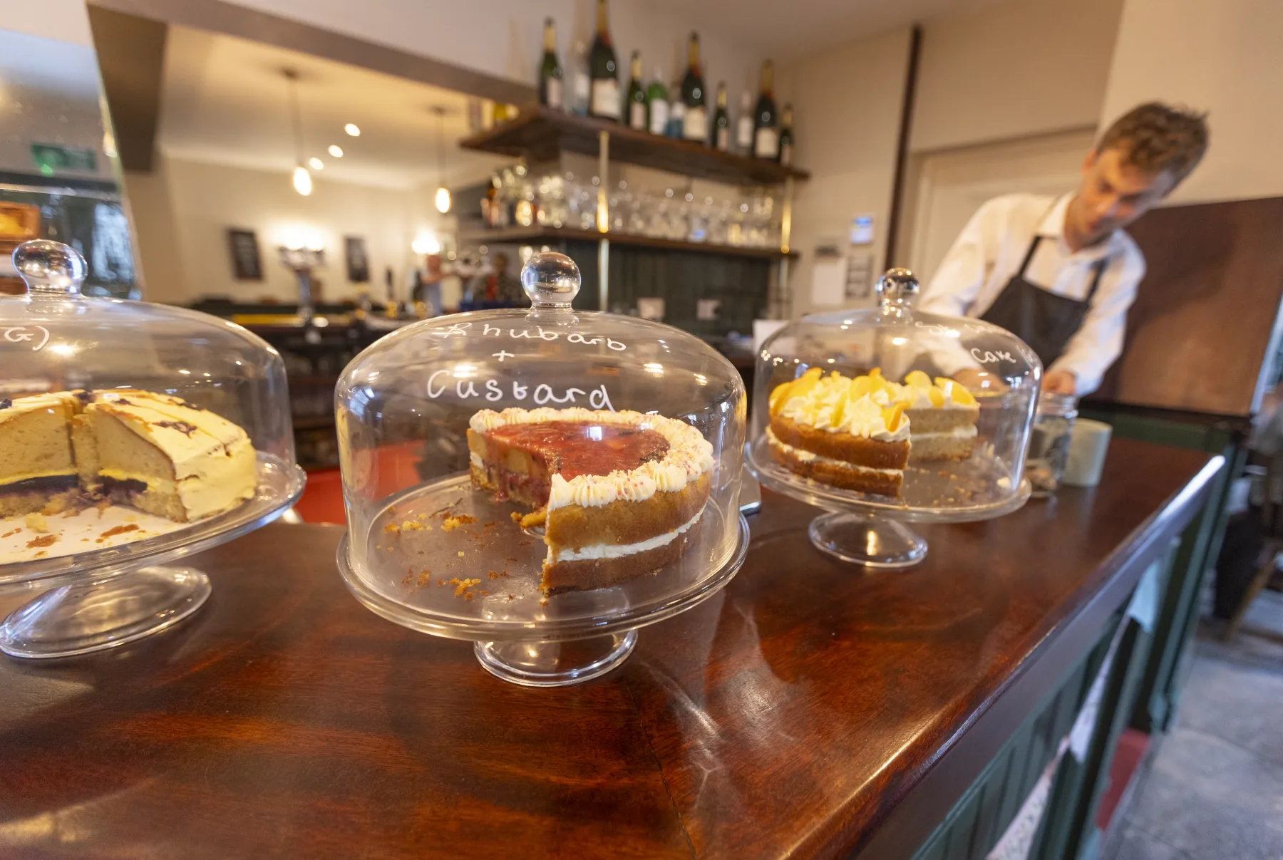 Cakes under glass on the café counter at The Black Lion