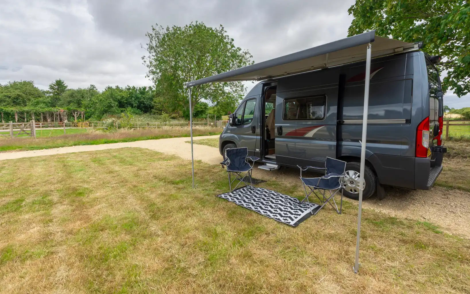A campervan set up on a touring pitch at The Black Lion